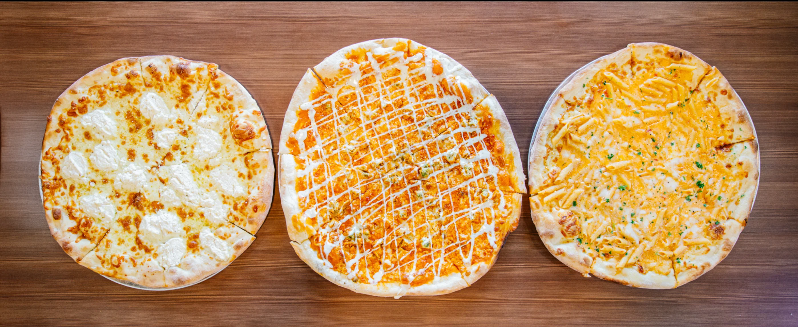 Three gourmet pizzas featuring unique toppings