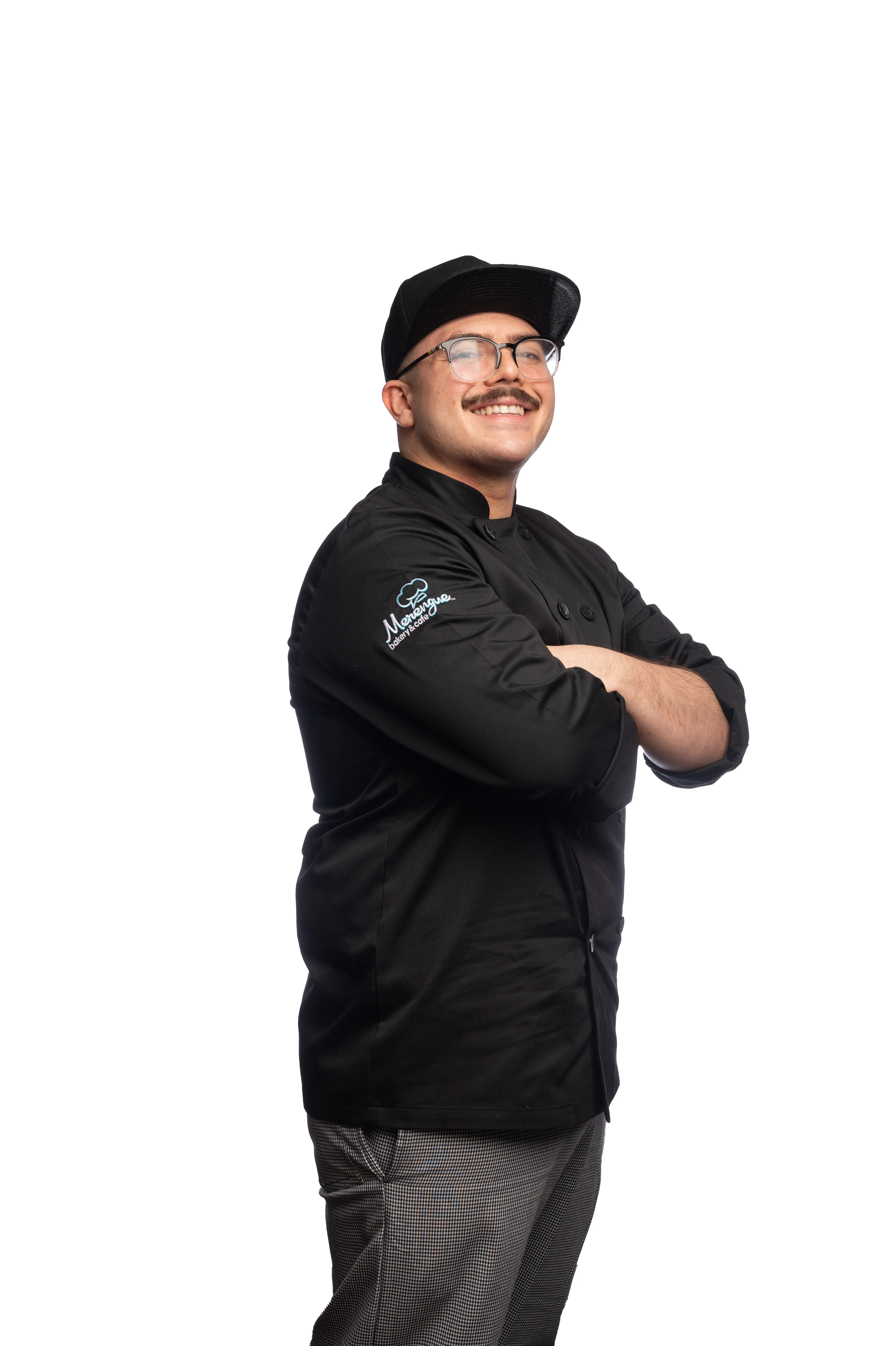 Chef in a black uniform smiling confidently