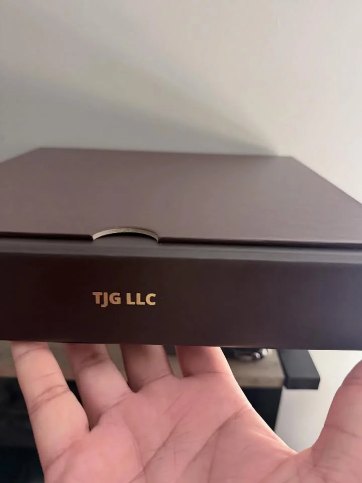 Elegant brown box with gold lettering for TJG LLC