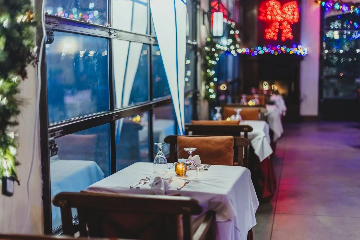 Elegant dining setup at Patio Ambassador with ambient lighting.