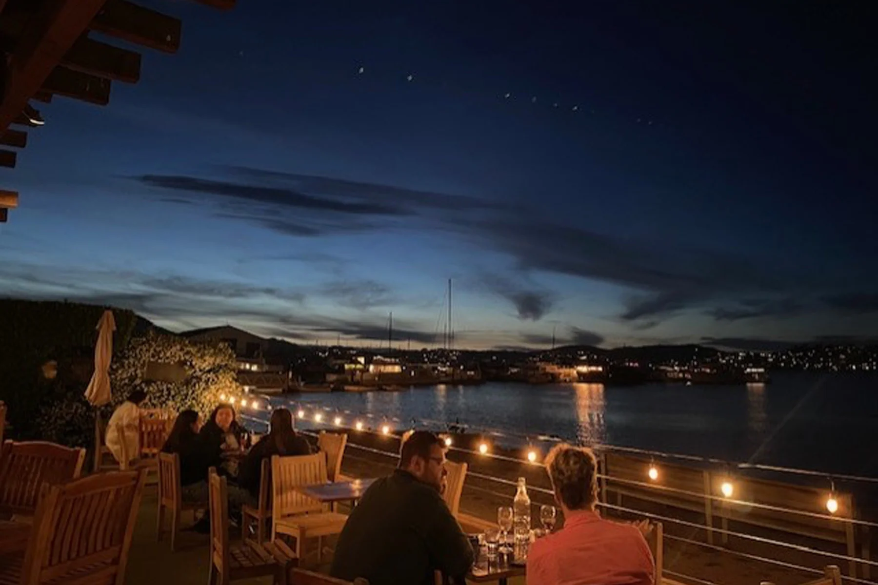 Bar Bocce diners looking out over the bay just after sunset