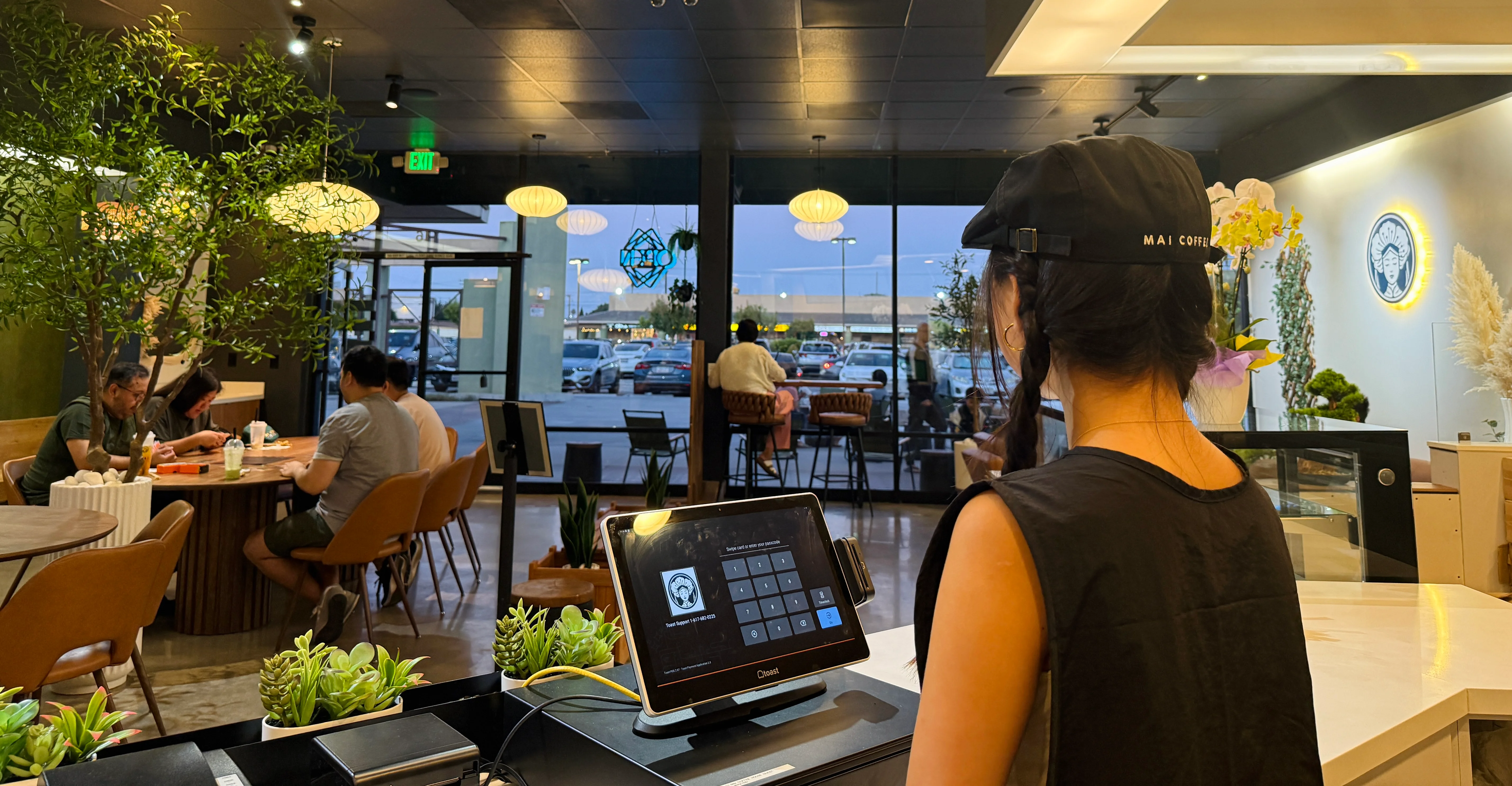 Modern café interior with customers enjoying drinks and a welcoming atmosphere