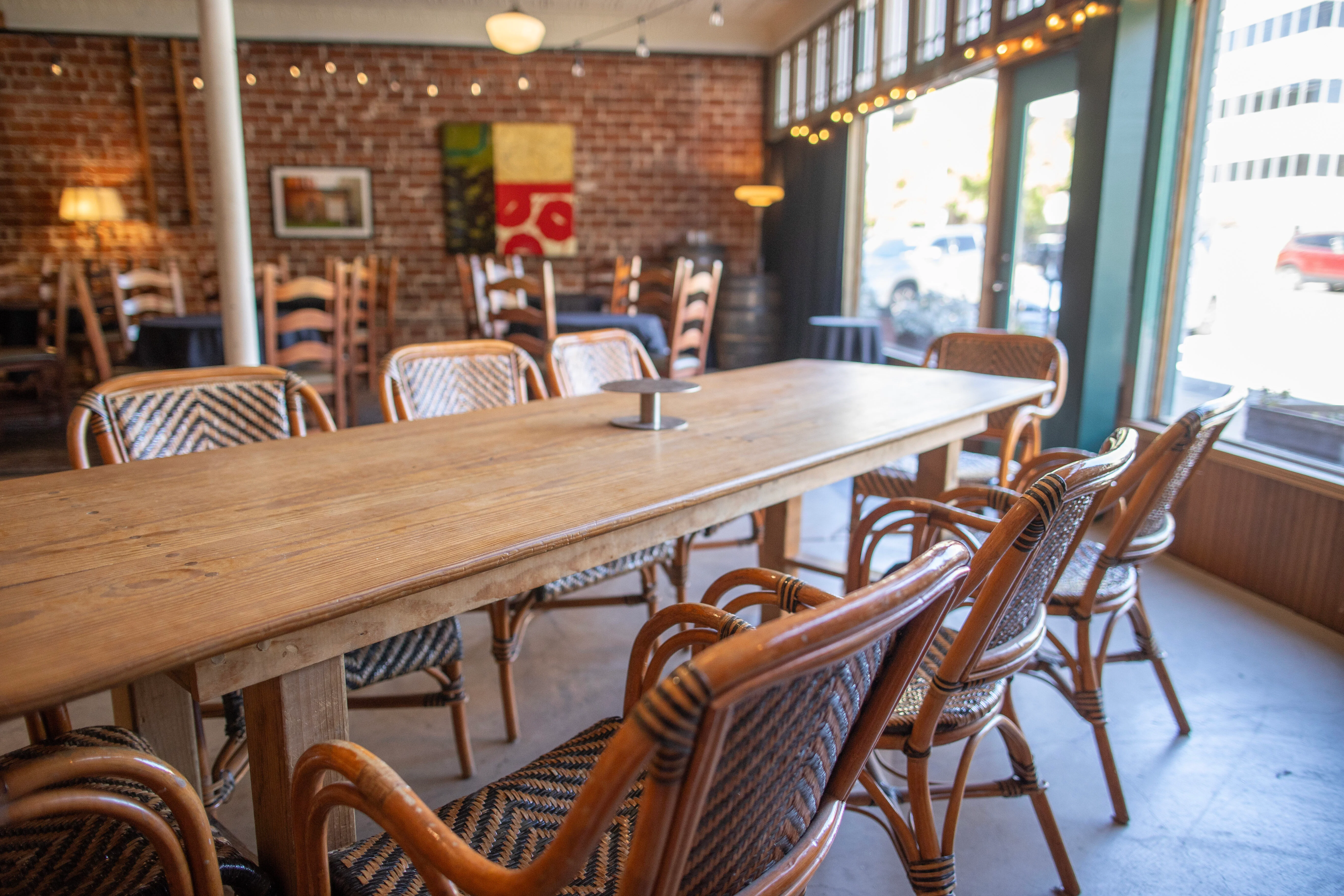 Cozy restaurant interior with wooden table and rattan chairs