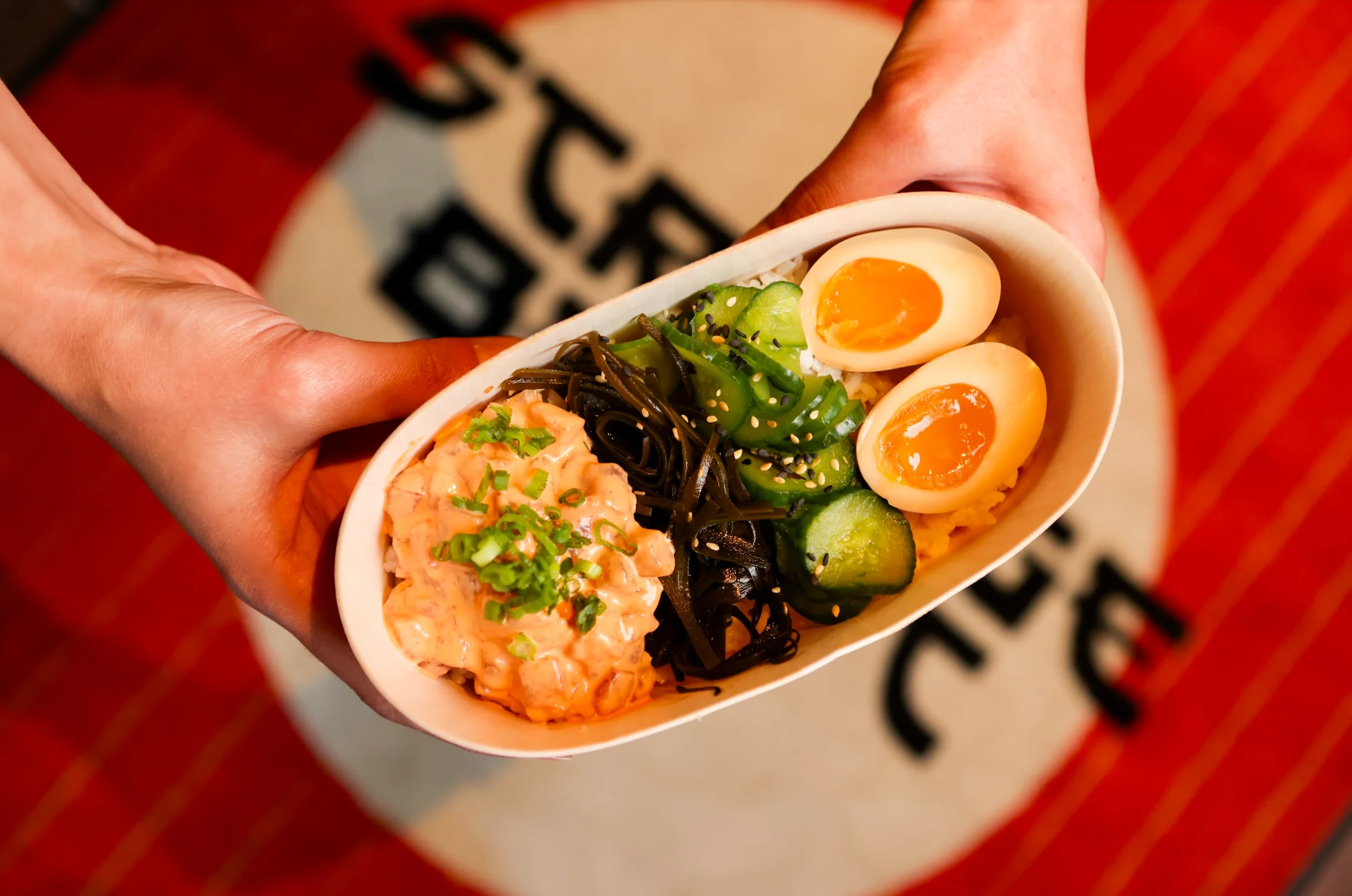 Japanese chirashi bowl with rice, vegetables, and soft-boiled eggs