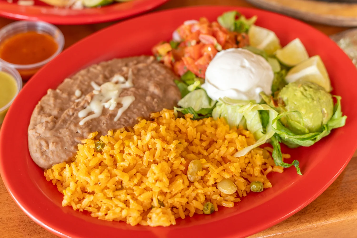 Traditional Mexican plate with rice, beans, and fresh toppings