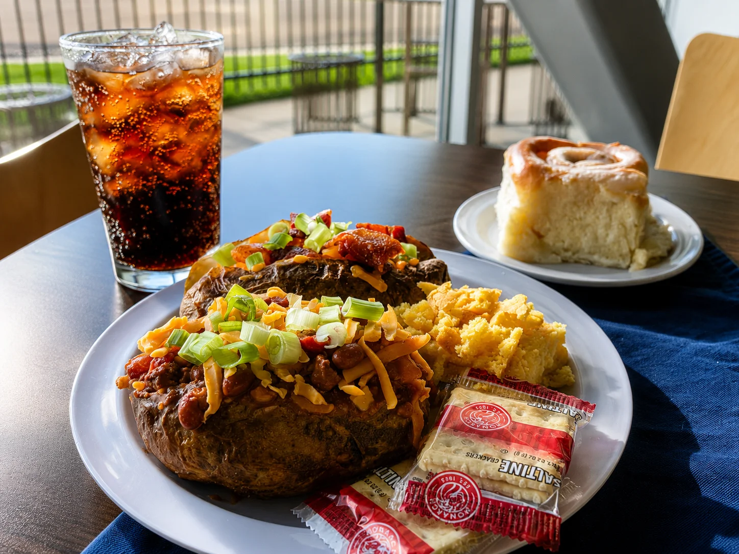 Loaded baked potato with chili and cornbread