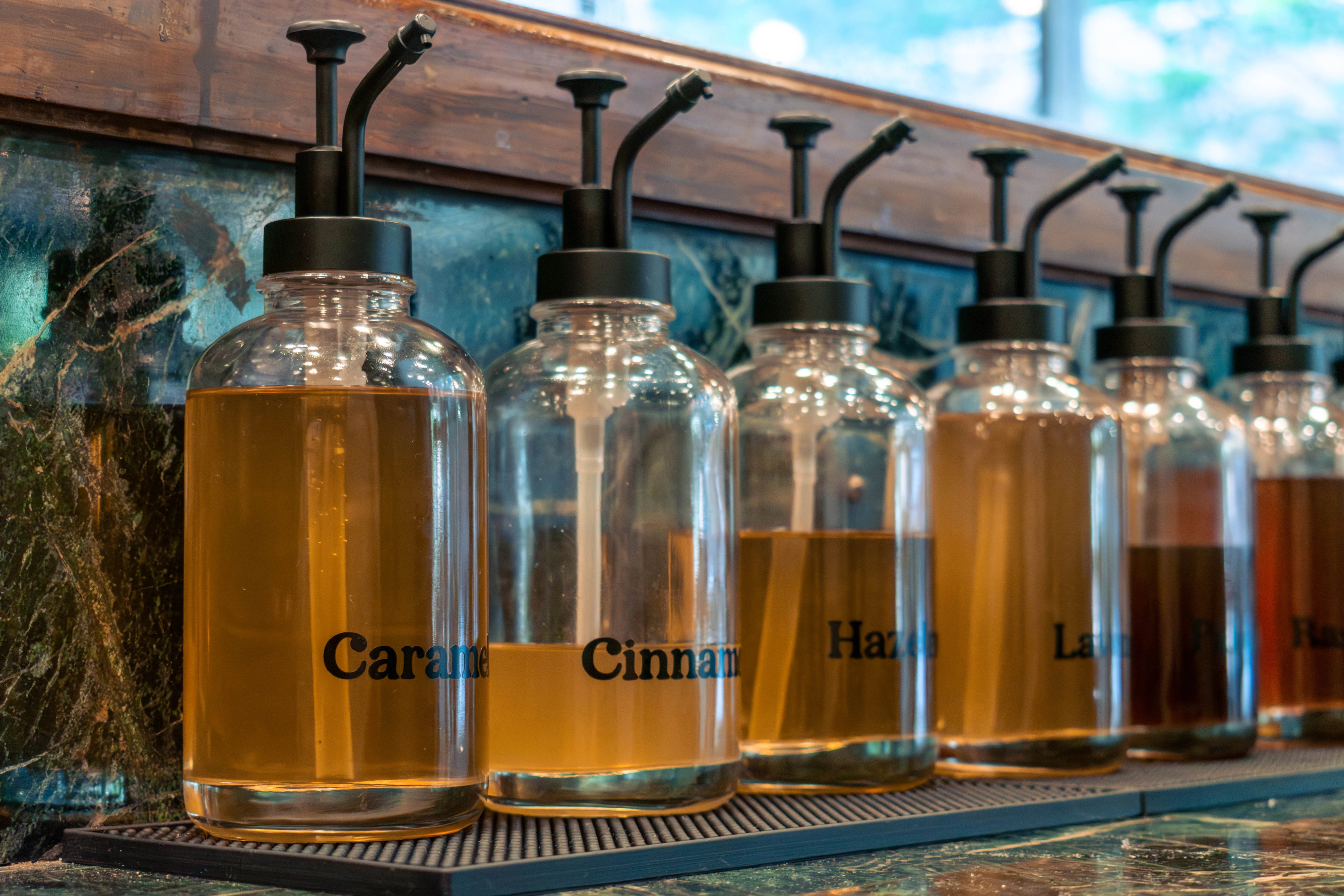 Bottles of flavored syrup all lined up