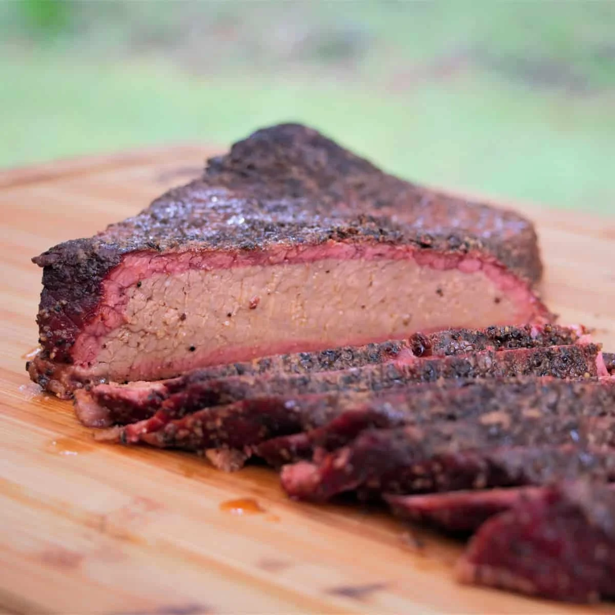 Smoked brisket sliced on a wooden cutting board