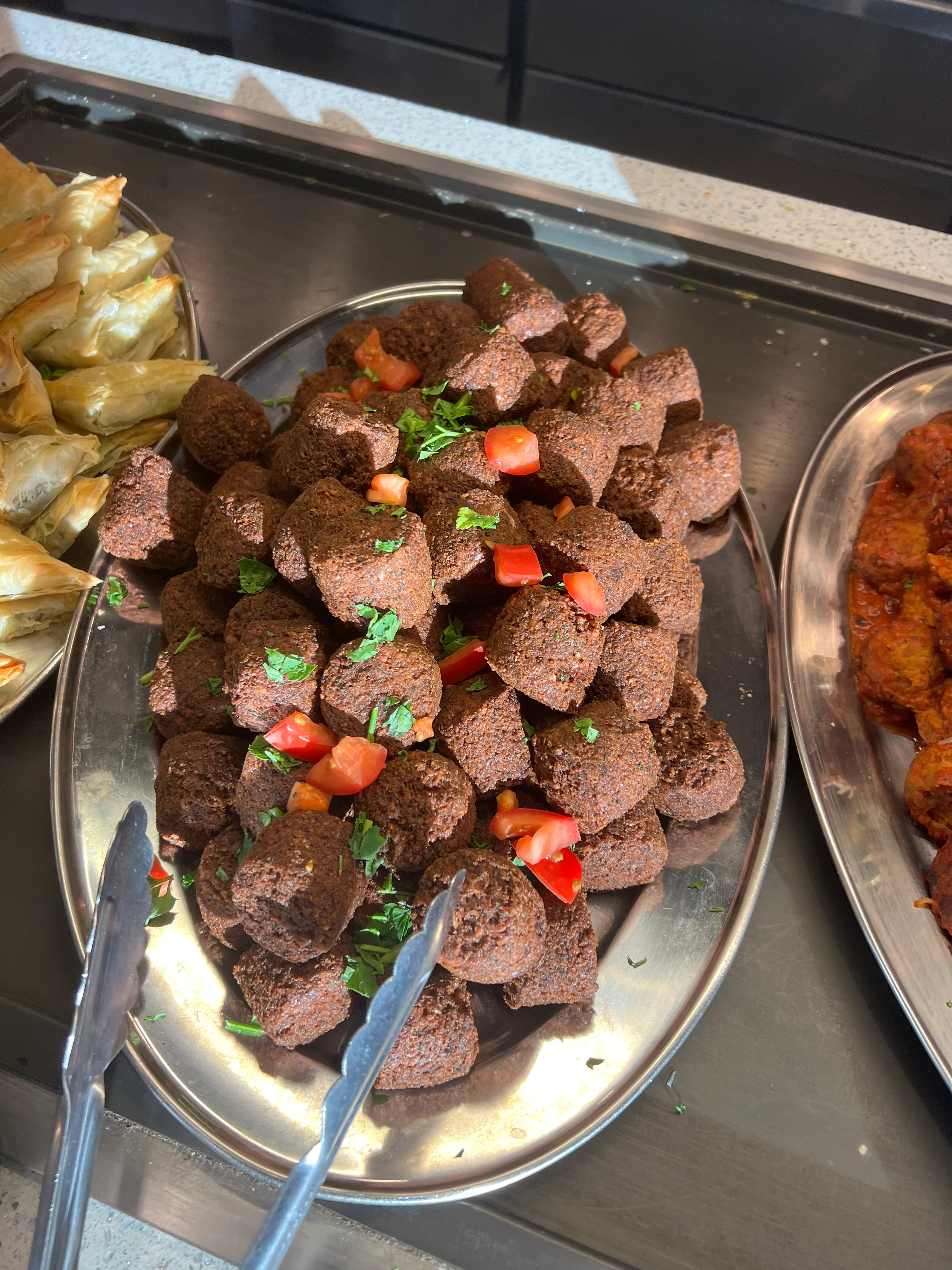 Mediterranean kibbeh served with fresh tomatoes and herbs