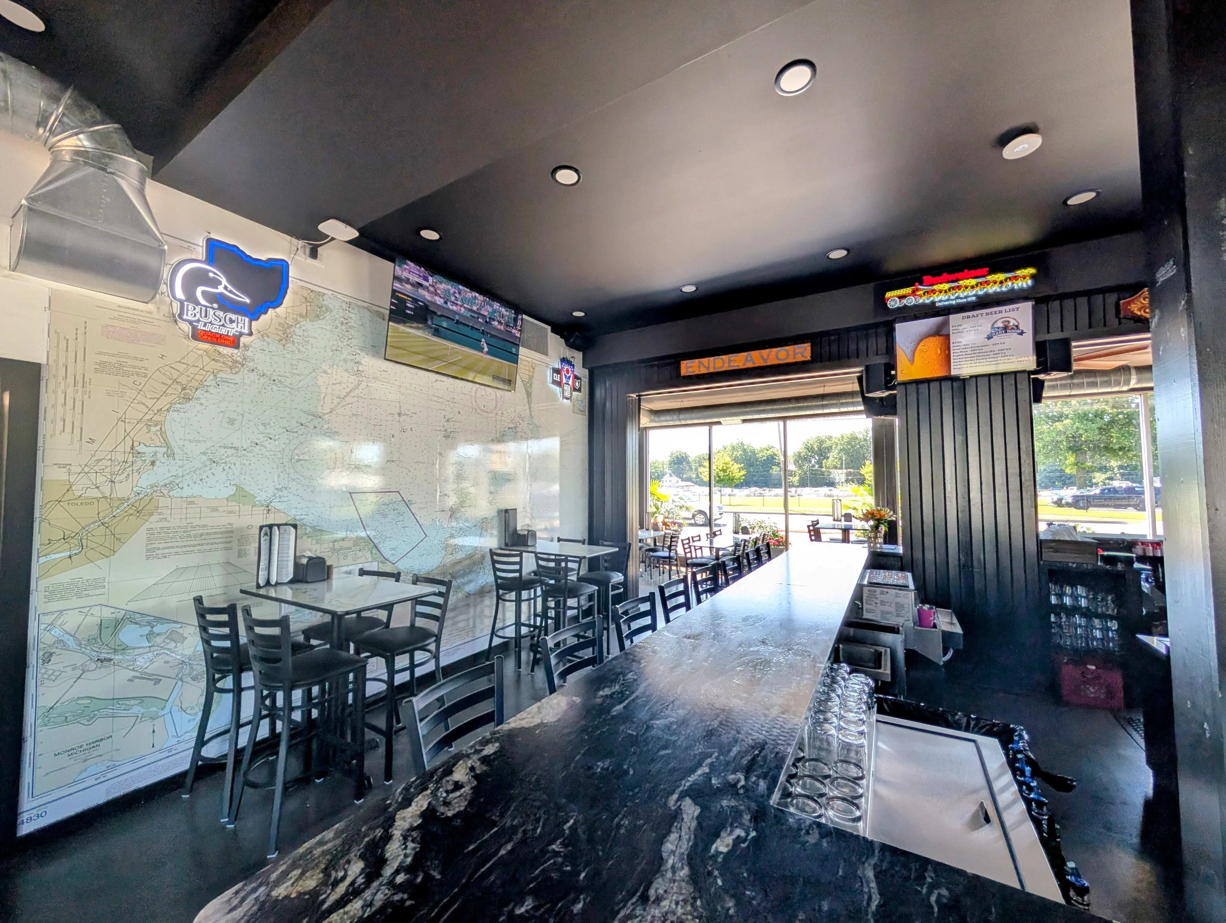 Modern restaurant interior with bar and map decor