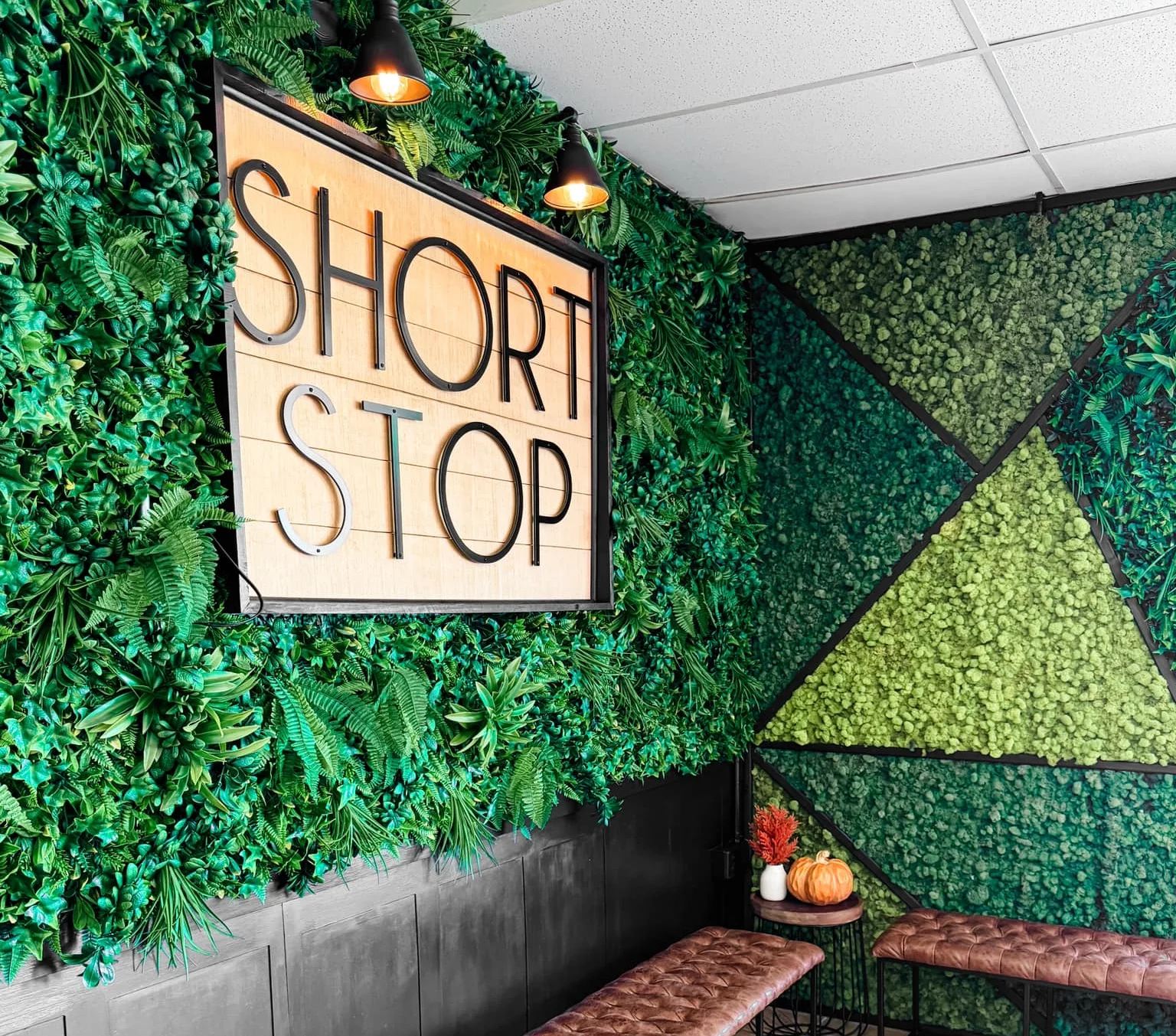 Cozy restaurant interior with green wall decor and seating