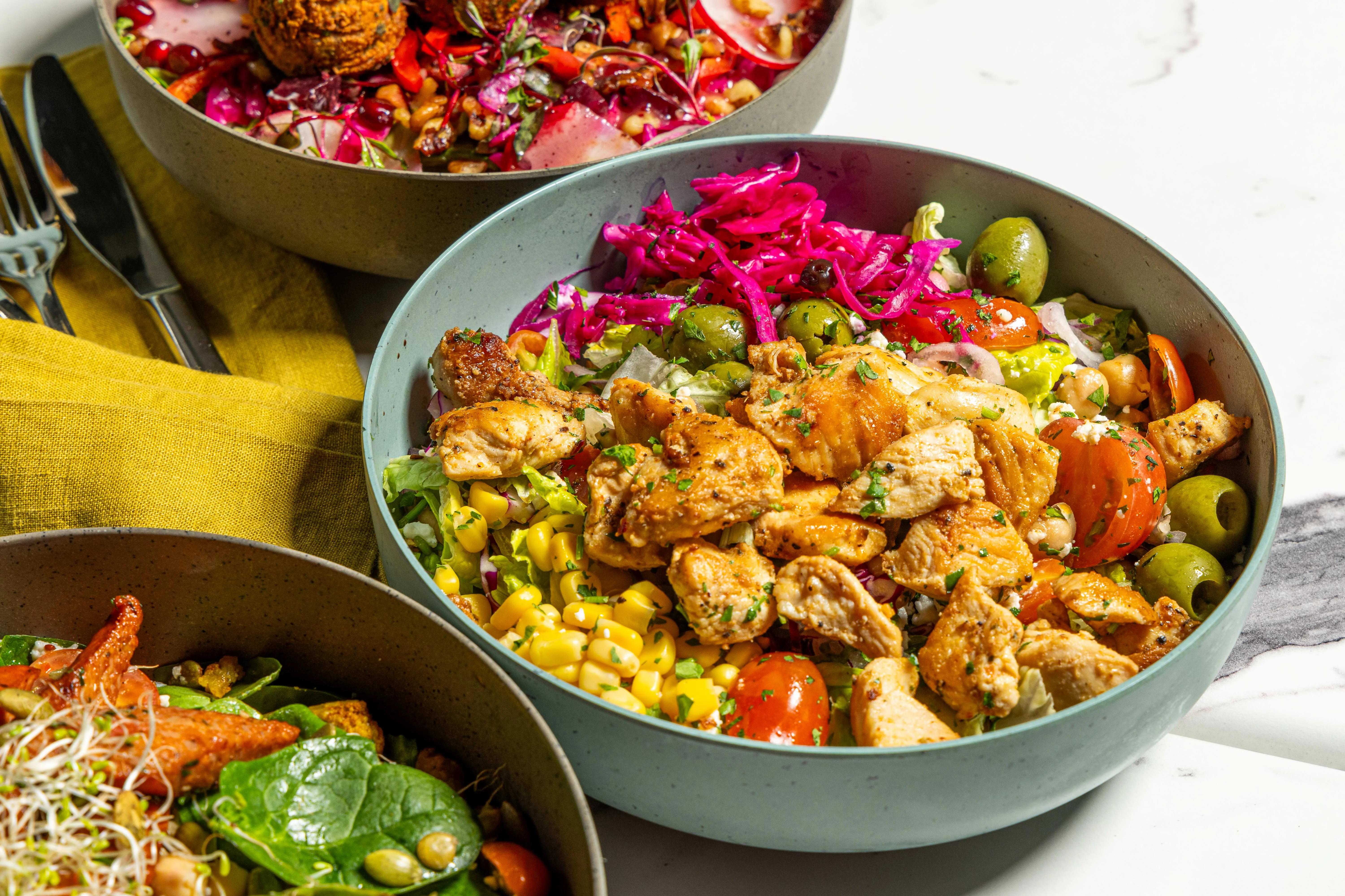 Mediterranean chicken salad bowl with vibrant toppings