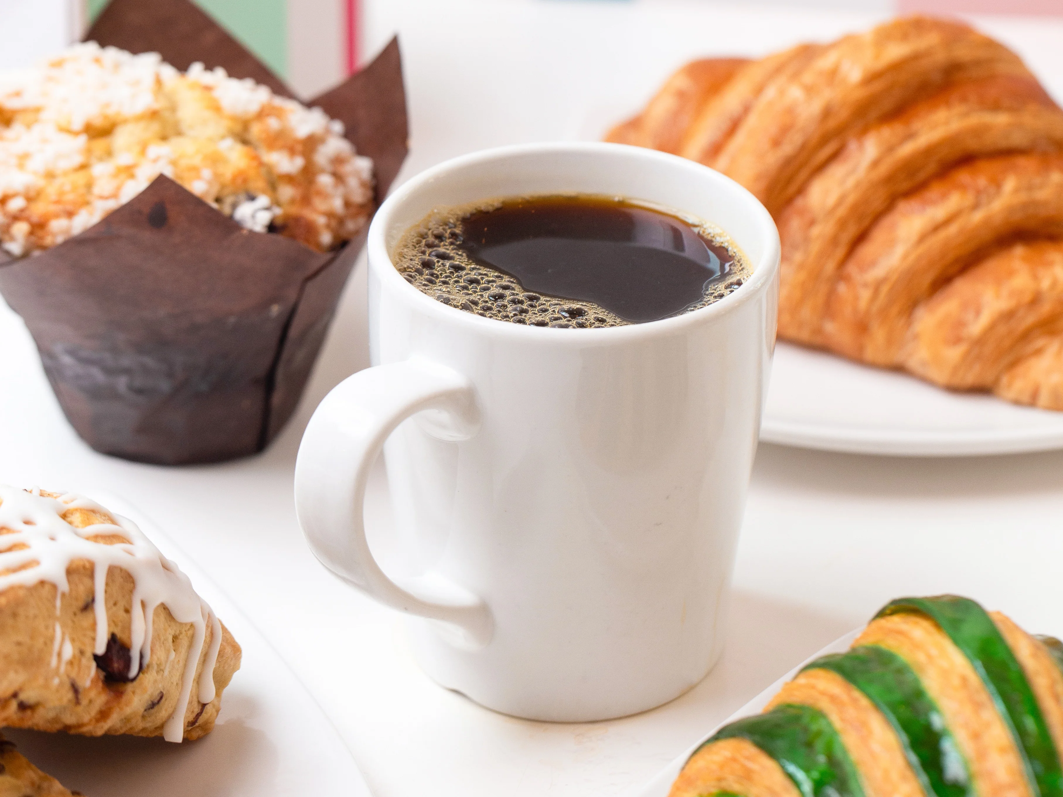 Freshly brewed coffee with pastries in a cozy café setting