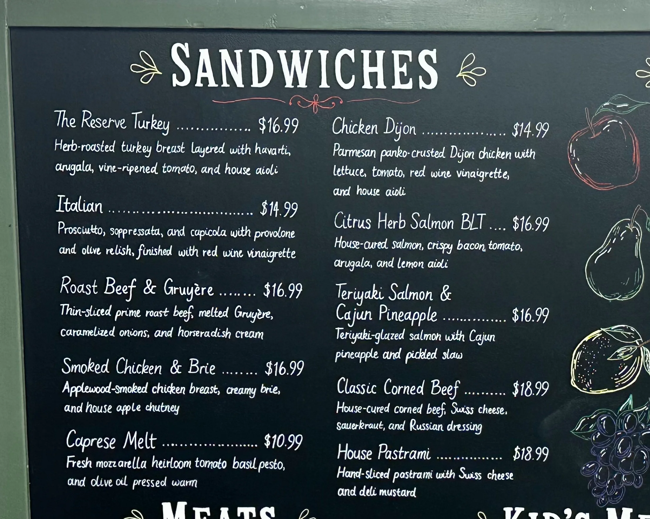 Restaurant menu featuring gourmet sandwiches and salads
