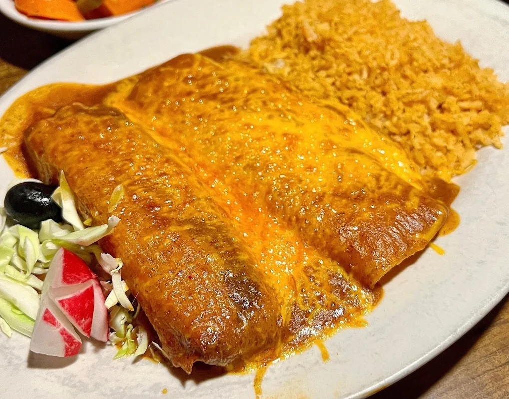 Cheesy enchiladas with rice and beans in a Mexican restaurant