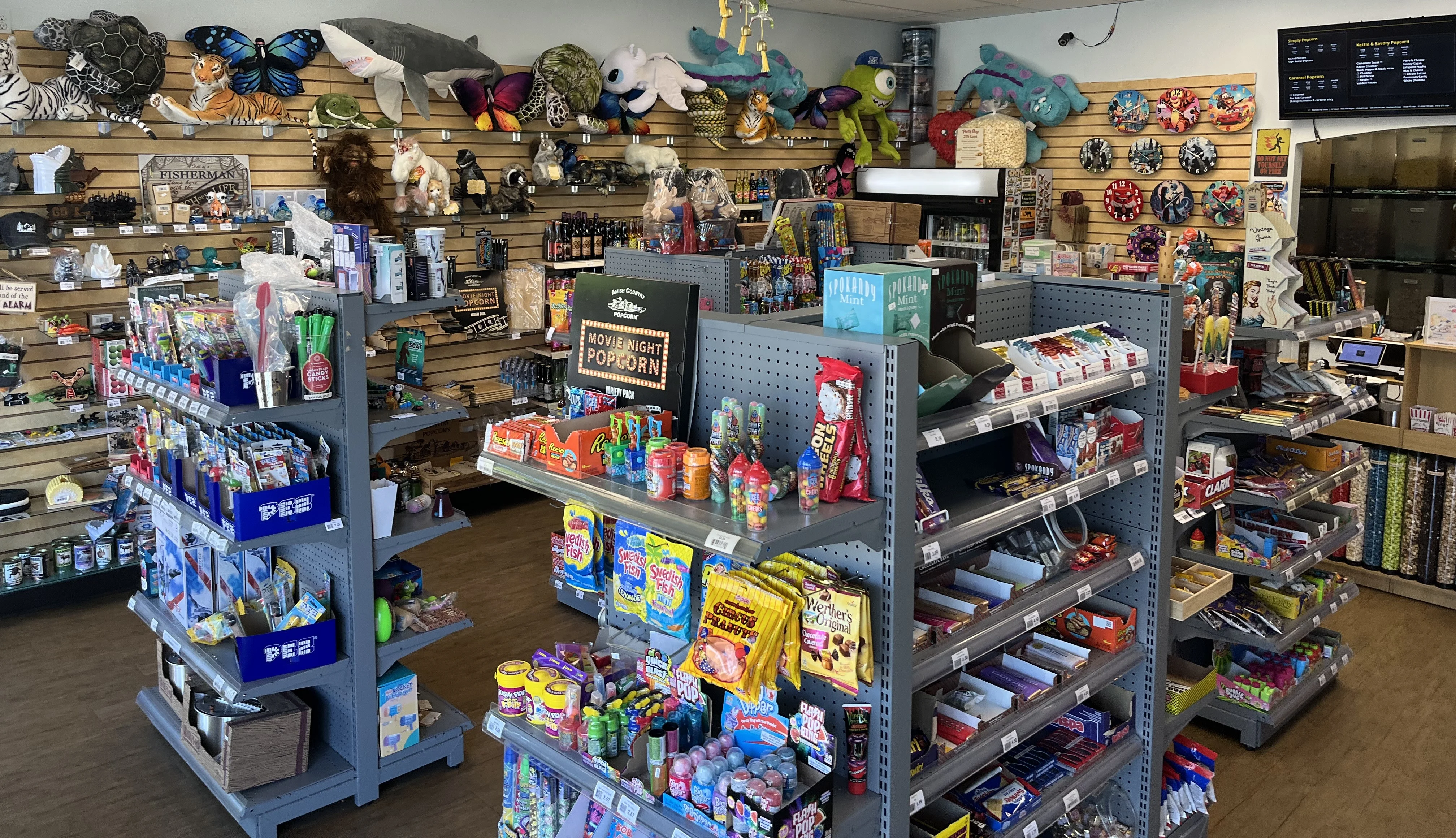 Colorful popcorn and candy shop interior with novelty gifts and wall displays Popcorn Cove