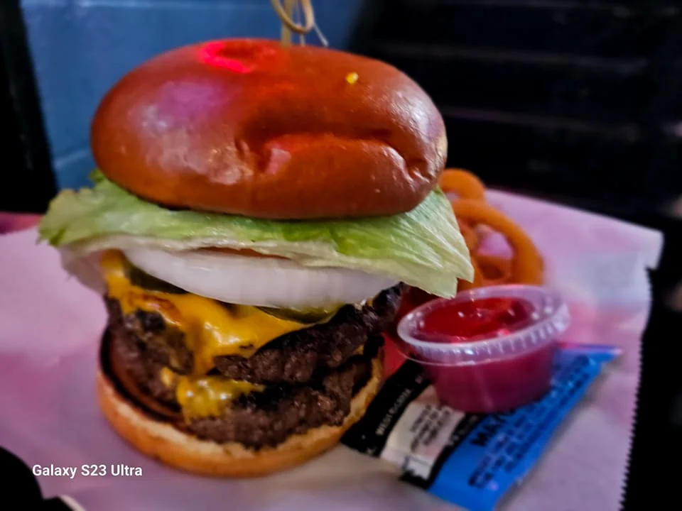 Juicy cheeseburger with lettuce and onion