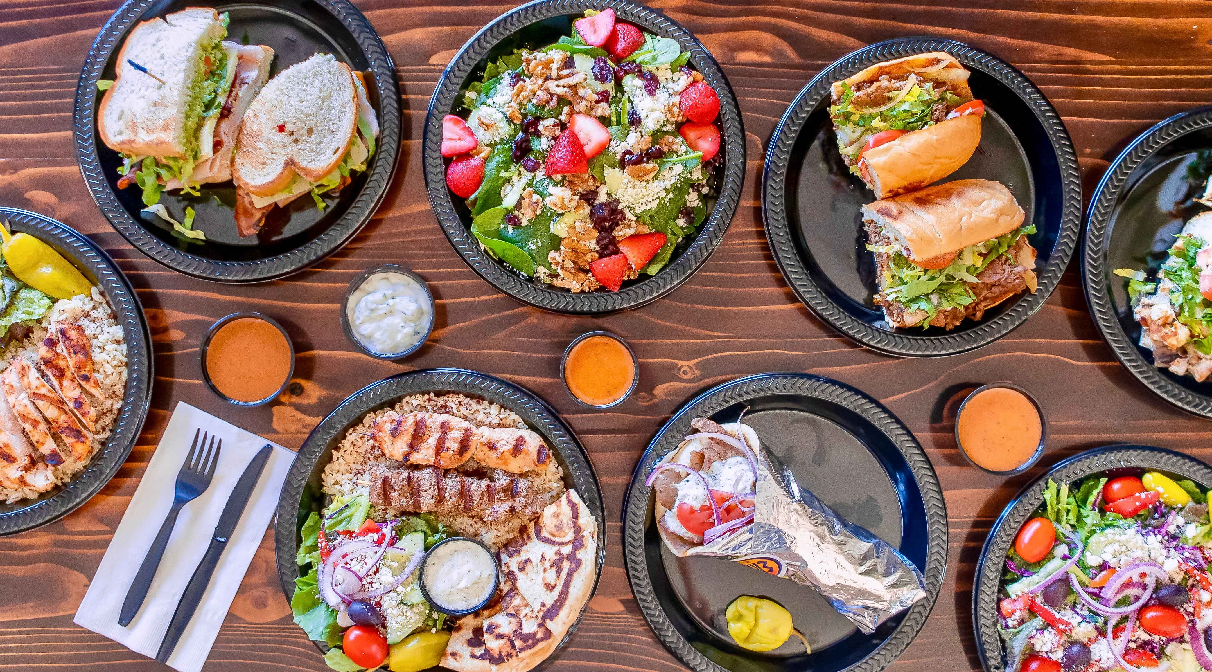 Assorted Mediterranean dishes including grilled chicken and salads