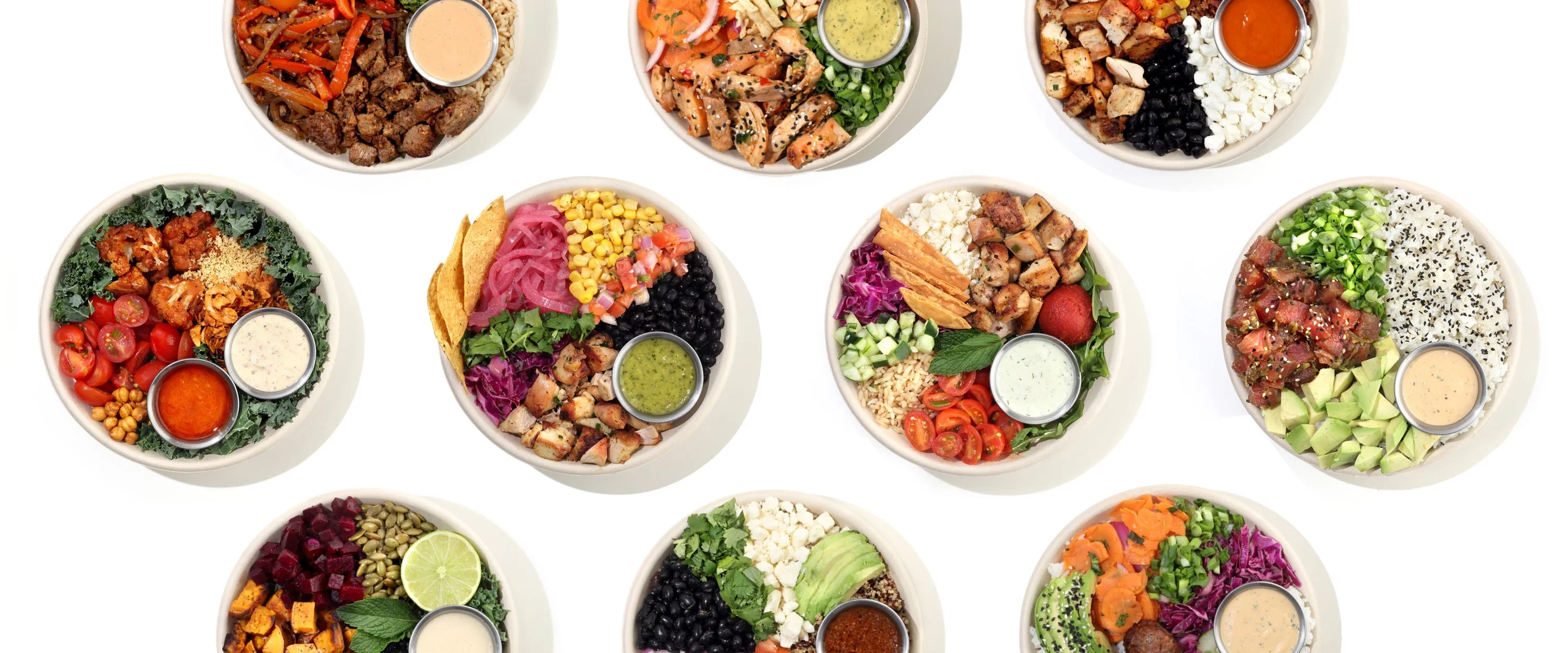 An assortment of Happy and Hale bowls featuring colorful and healthy ingredients such as tomatoes, chicken, corn, cucumbers, and yummy sauces.