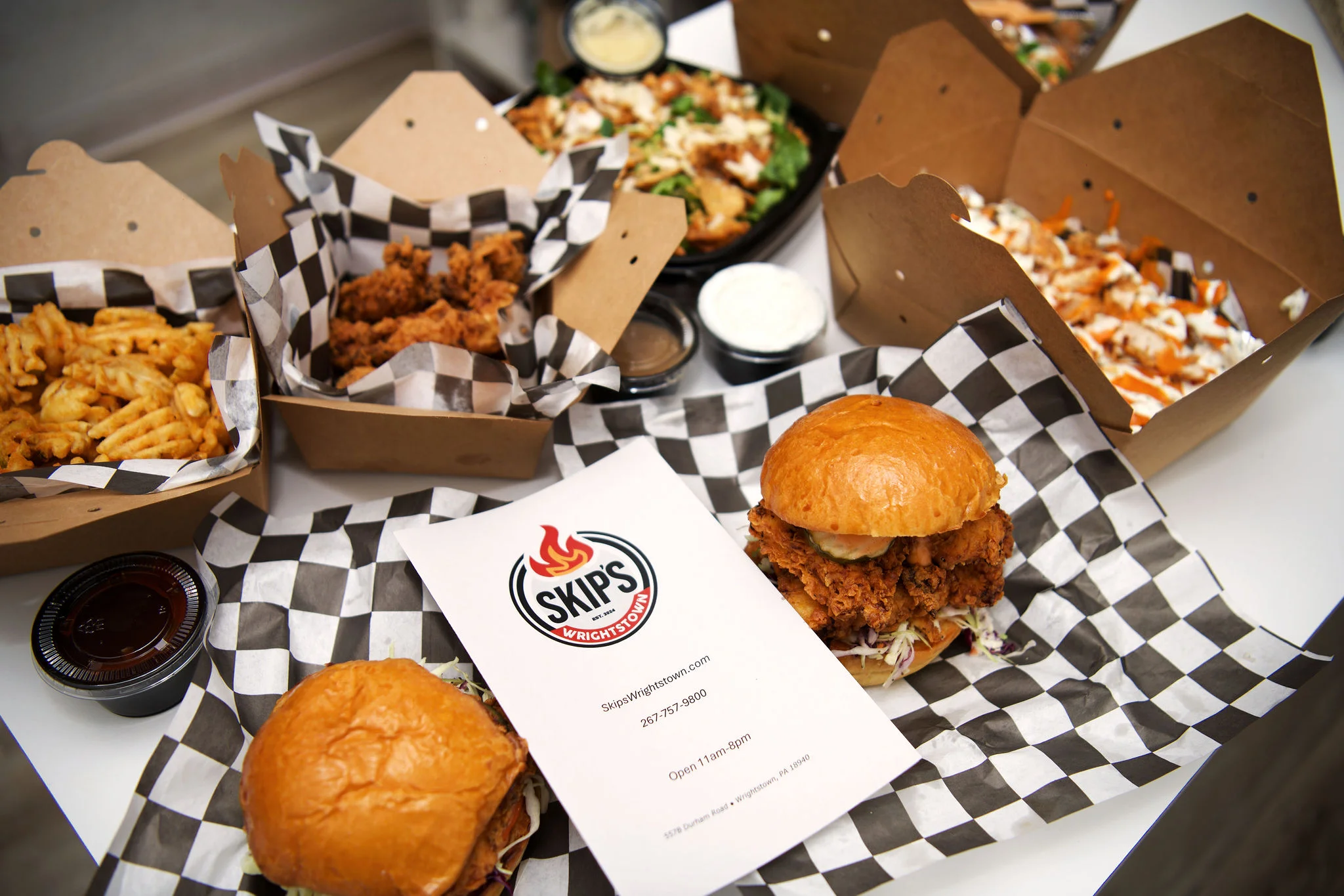 Crispy fried chicken sandwiches with sides in a casual dining setting