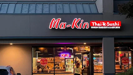 Exterior of Ma-Kin Thai & Sushi restaurant with neon signage
