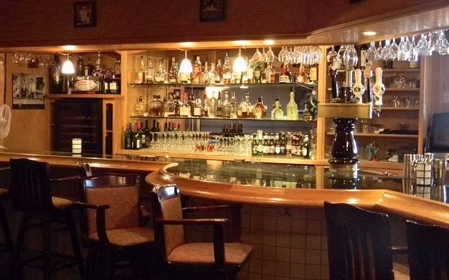 Cozy bar interior with a well-stocked liquor shelf