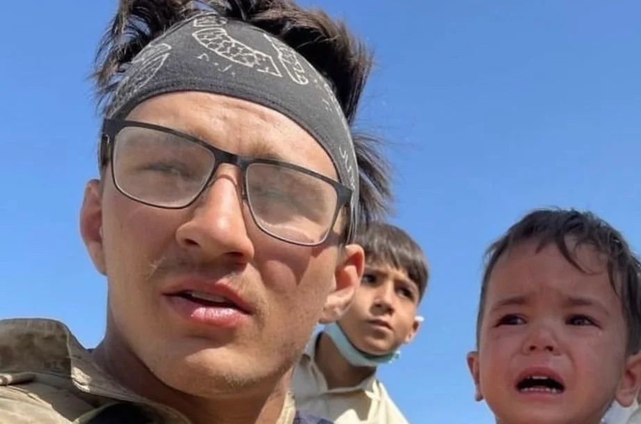 Soldier comforting a crying child in a tense environment