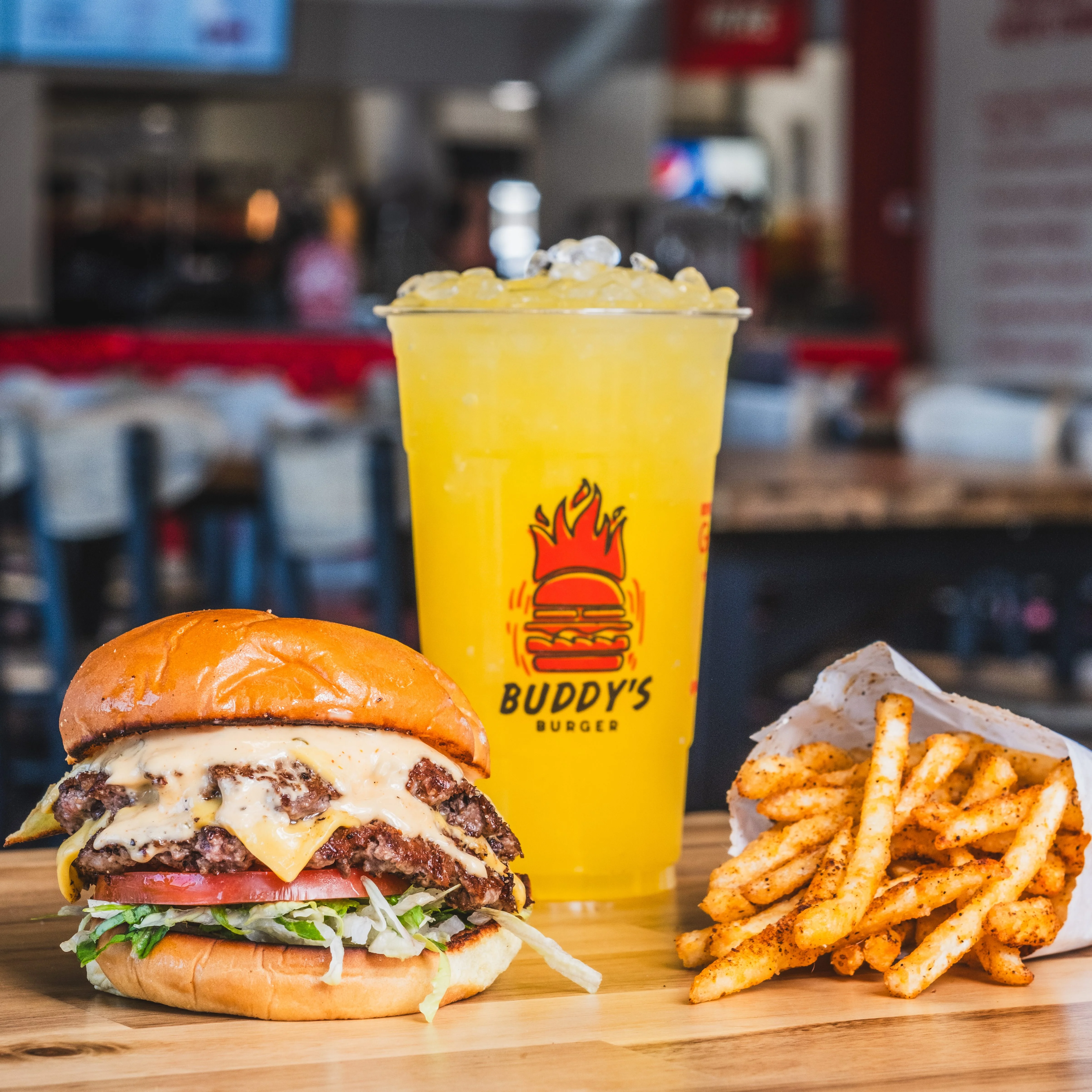 Juicy cheeseburger with fries and a refreshing drink