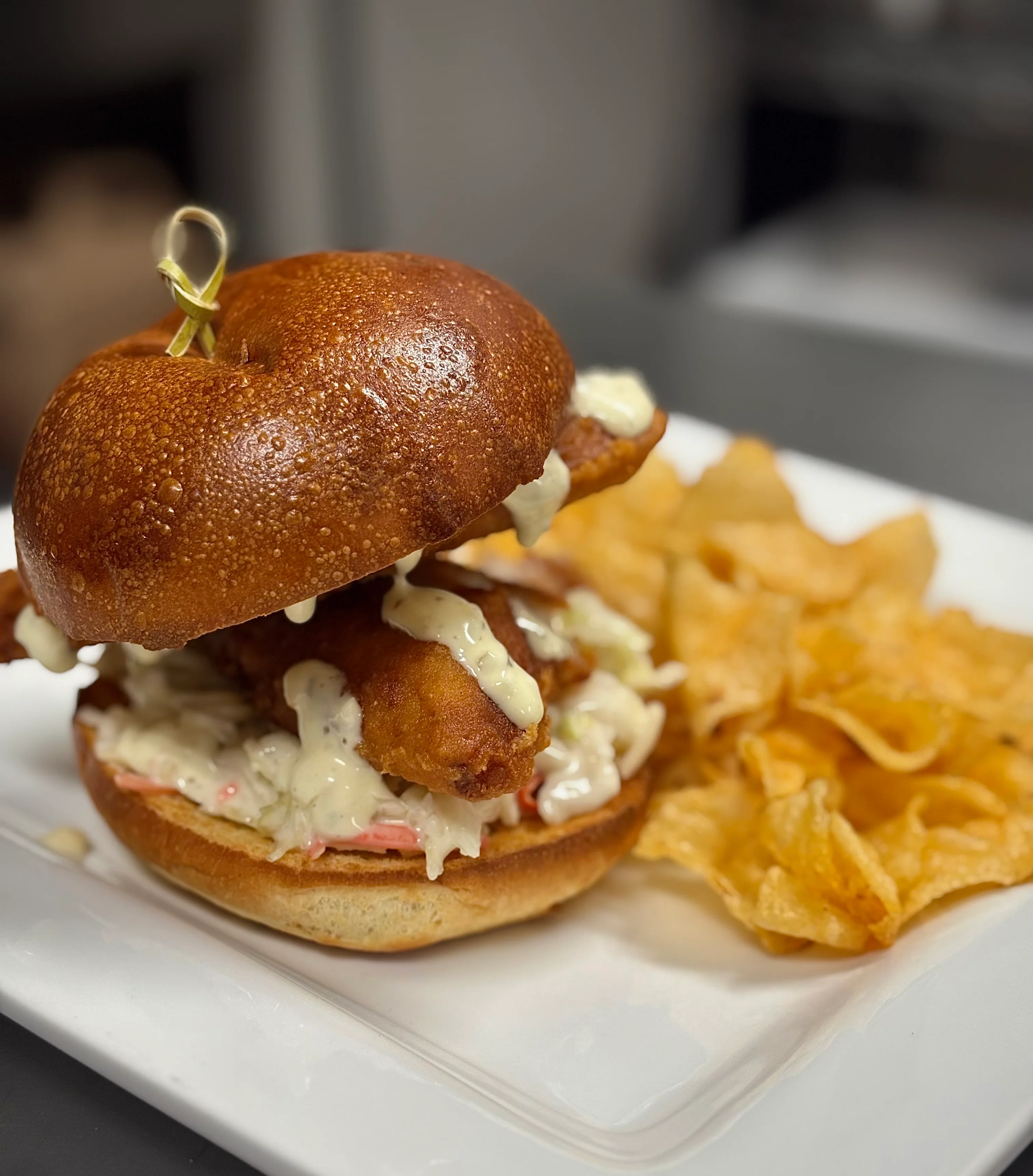 Crispy fish sandwich with coleslaw and chips