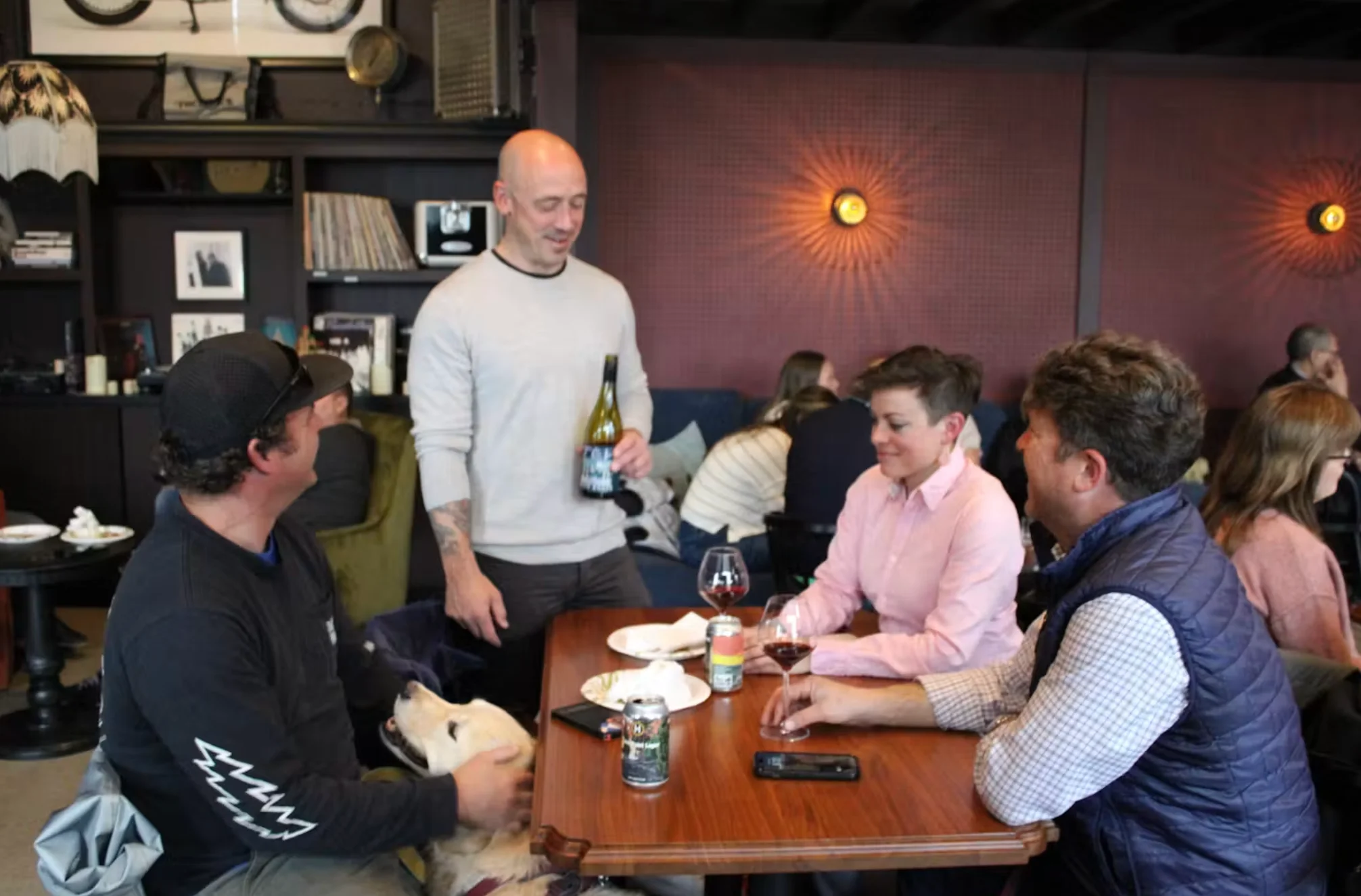 Social gathering in a cozy restaurant with friends and a dog
