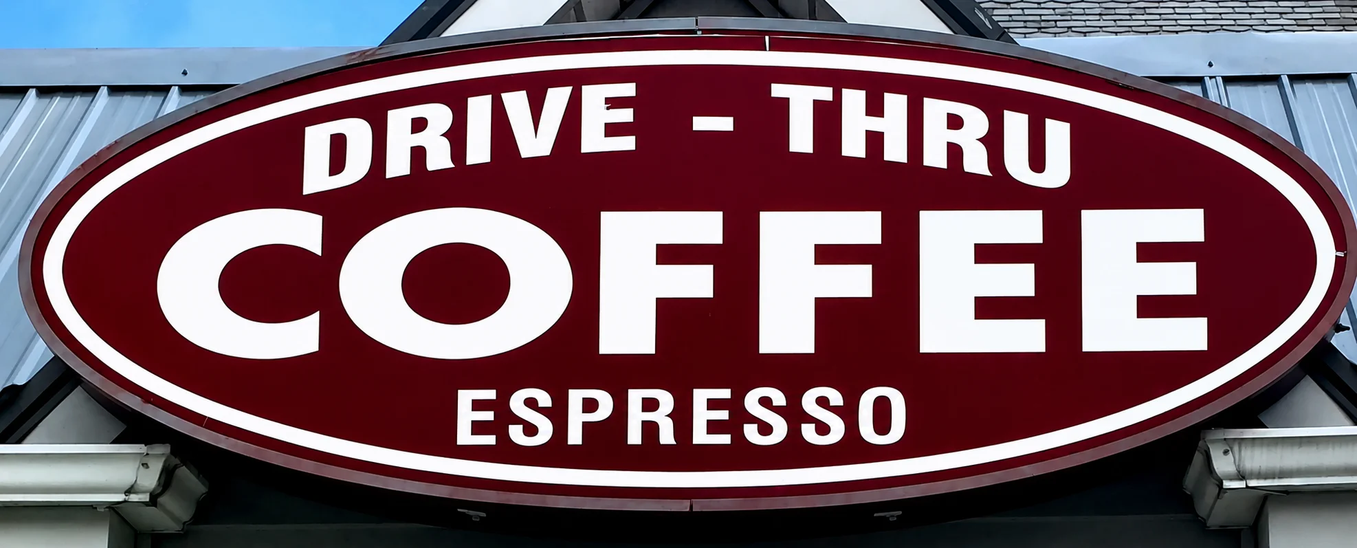 Drive-thru coffee shop sign with espresso offerings