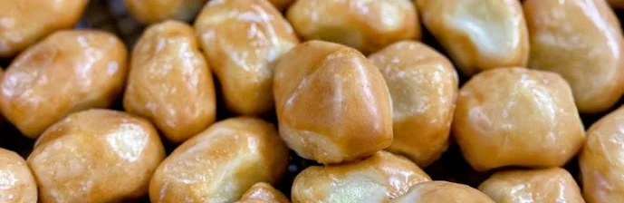Golden fried Chinese doughnuts on a cooling rack