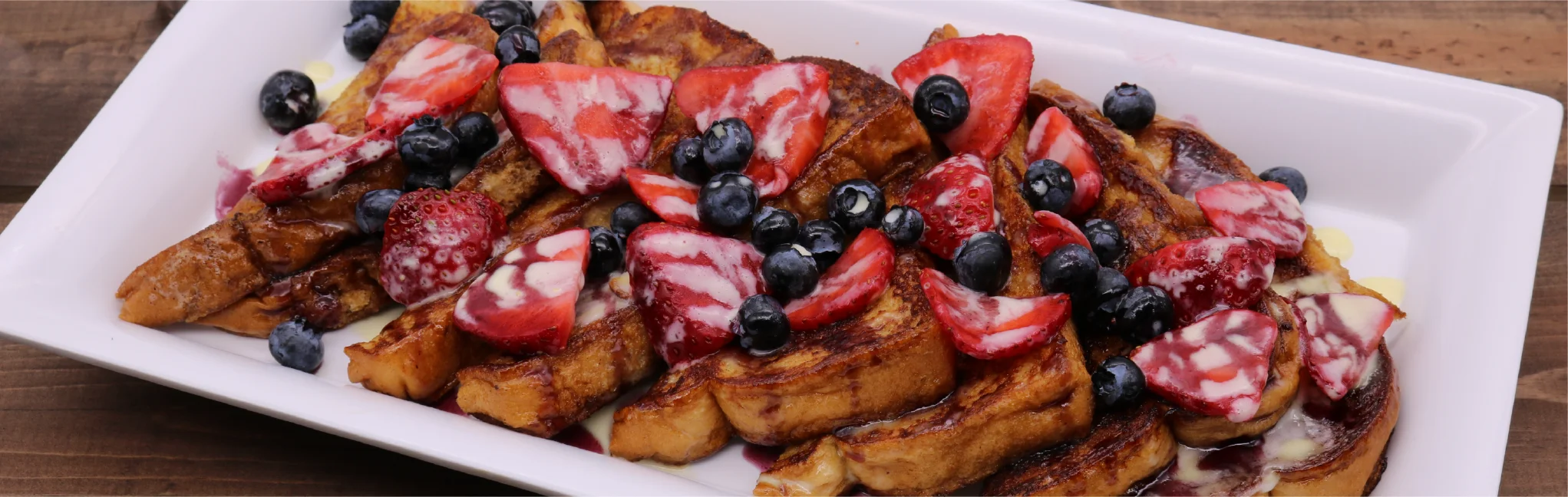 French toast topped with strawberries and blueberries