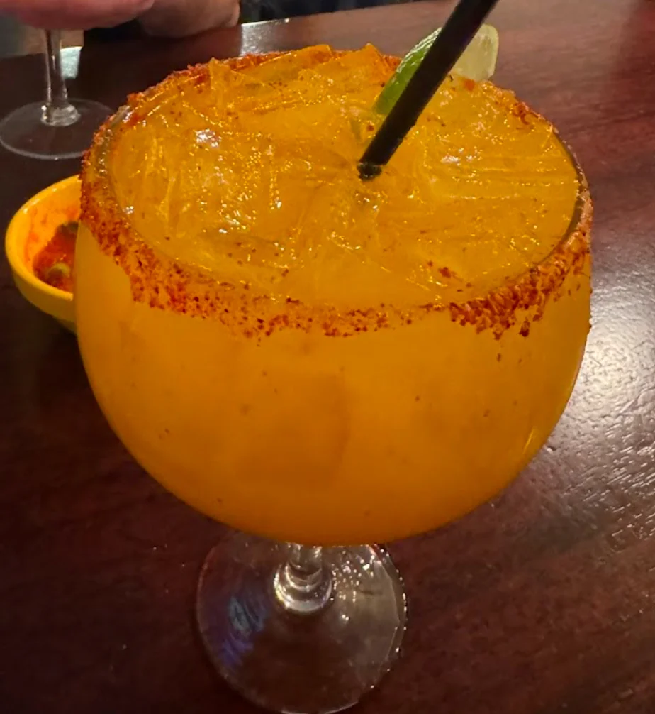 Vibrant margarita cocktail with chili rim