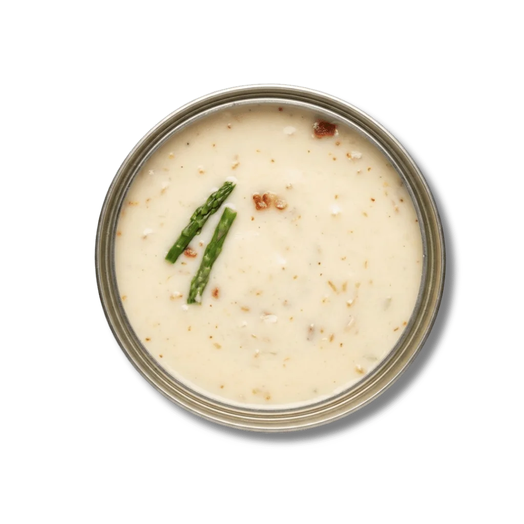 Creamy soup with asparagus and crunchy toppings in a bowl.