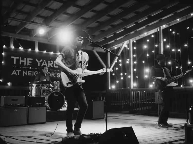 Live music performance at The Yard with vibrant lights and musicians on stage