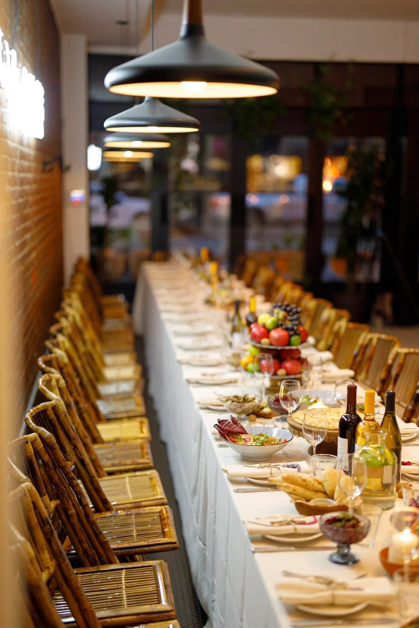 Elegant dining setup with a long table and assorted fruits