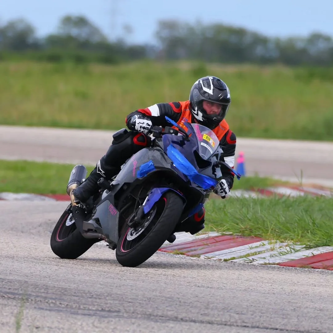 Motorcycle racer leaning into a racetrack corner