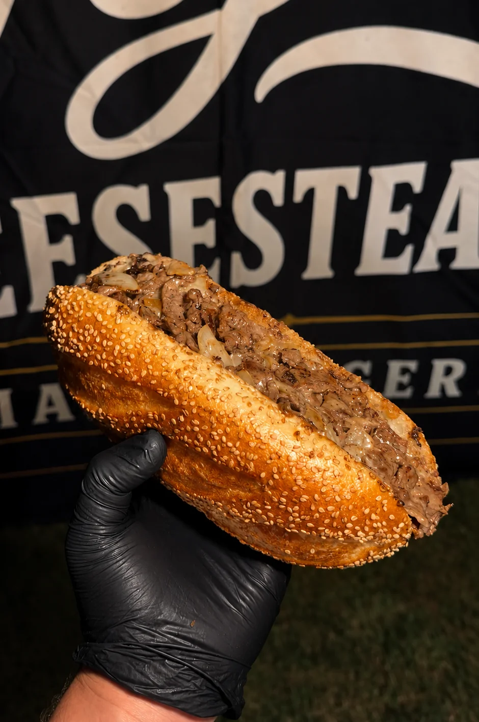 Delicious cheesesteak sandwich with sautéed onions in a sesame seed bun