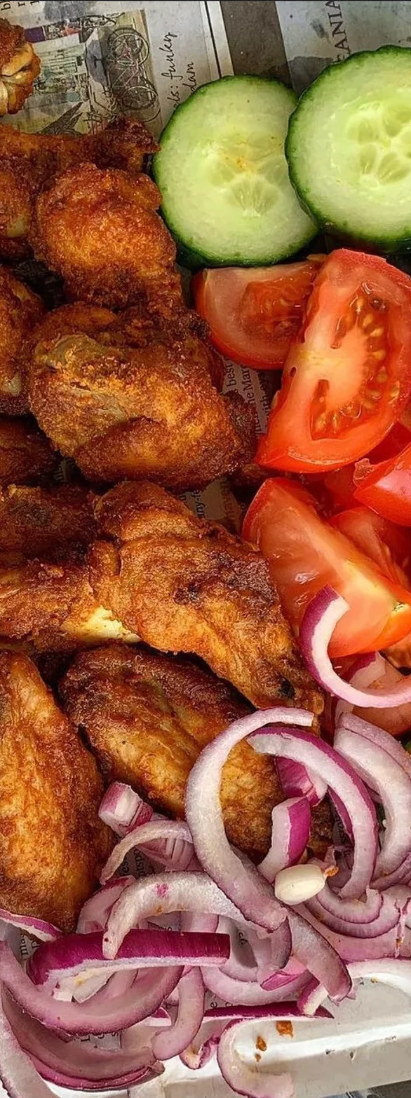 Crispy Nigerian chicken wings with fresh vegetables