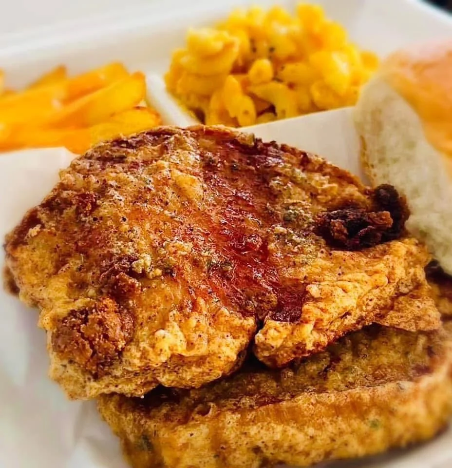 Southern fried chicken with sides of macaroni and fries