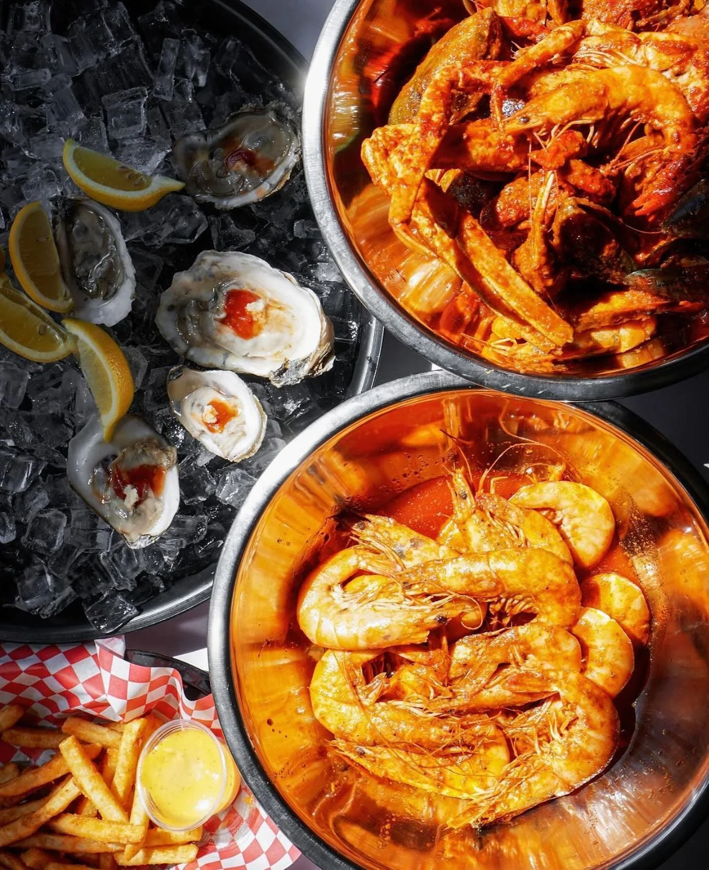 Seafood boil featuring shrimp and oysters on ice