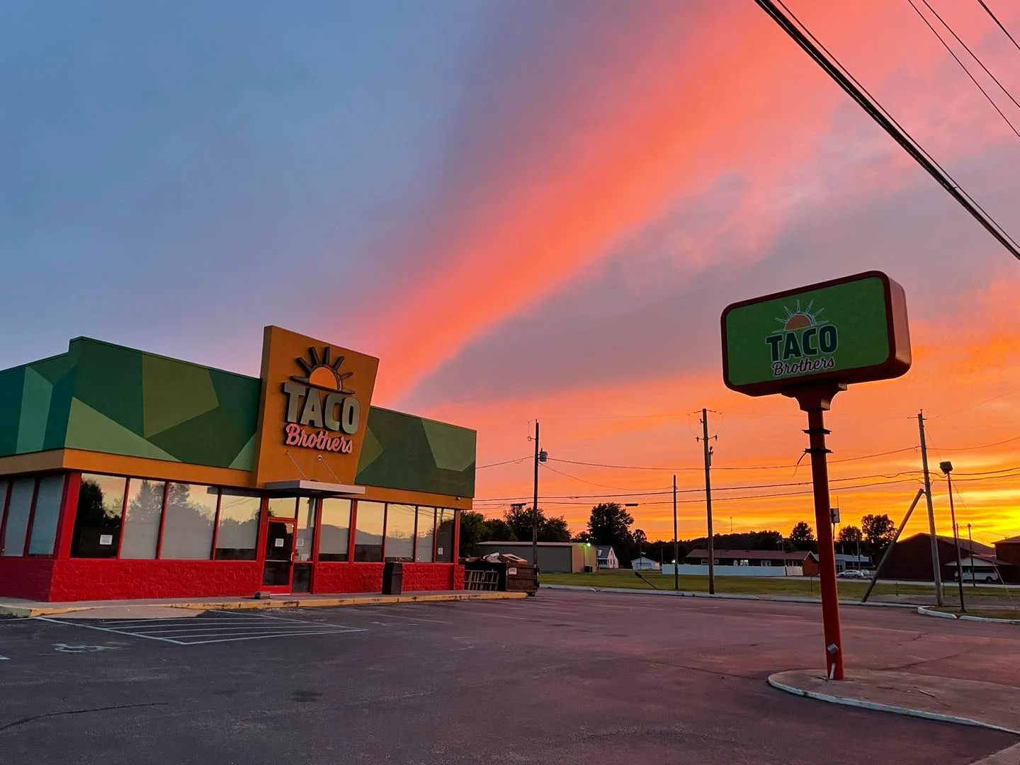 Colorful taco restaurant exterior at sunset