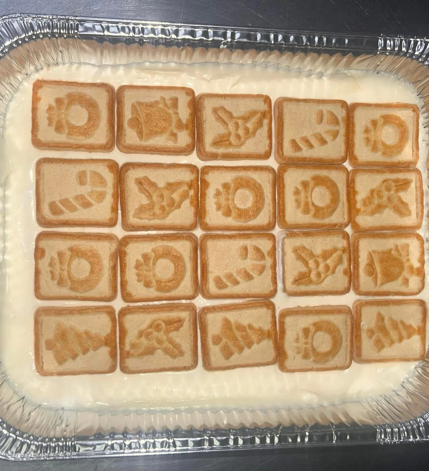 Festive holiday dessert with decorated cookies on creamy base