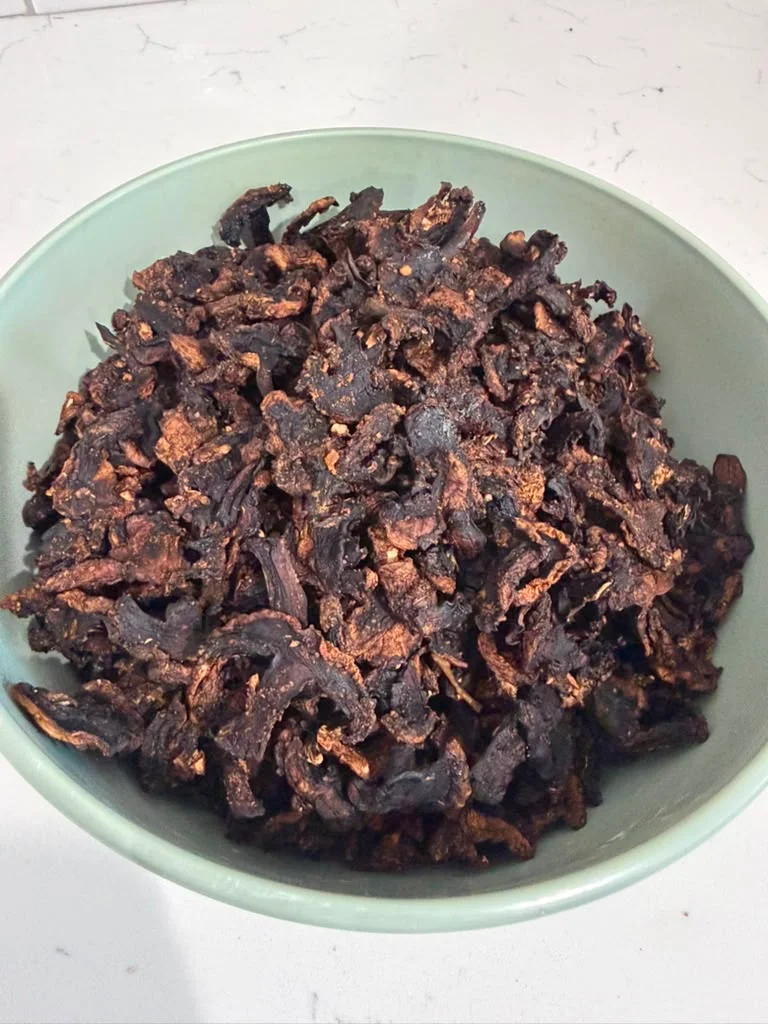 Crispy fried eggplant chips in a green bowl