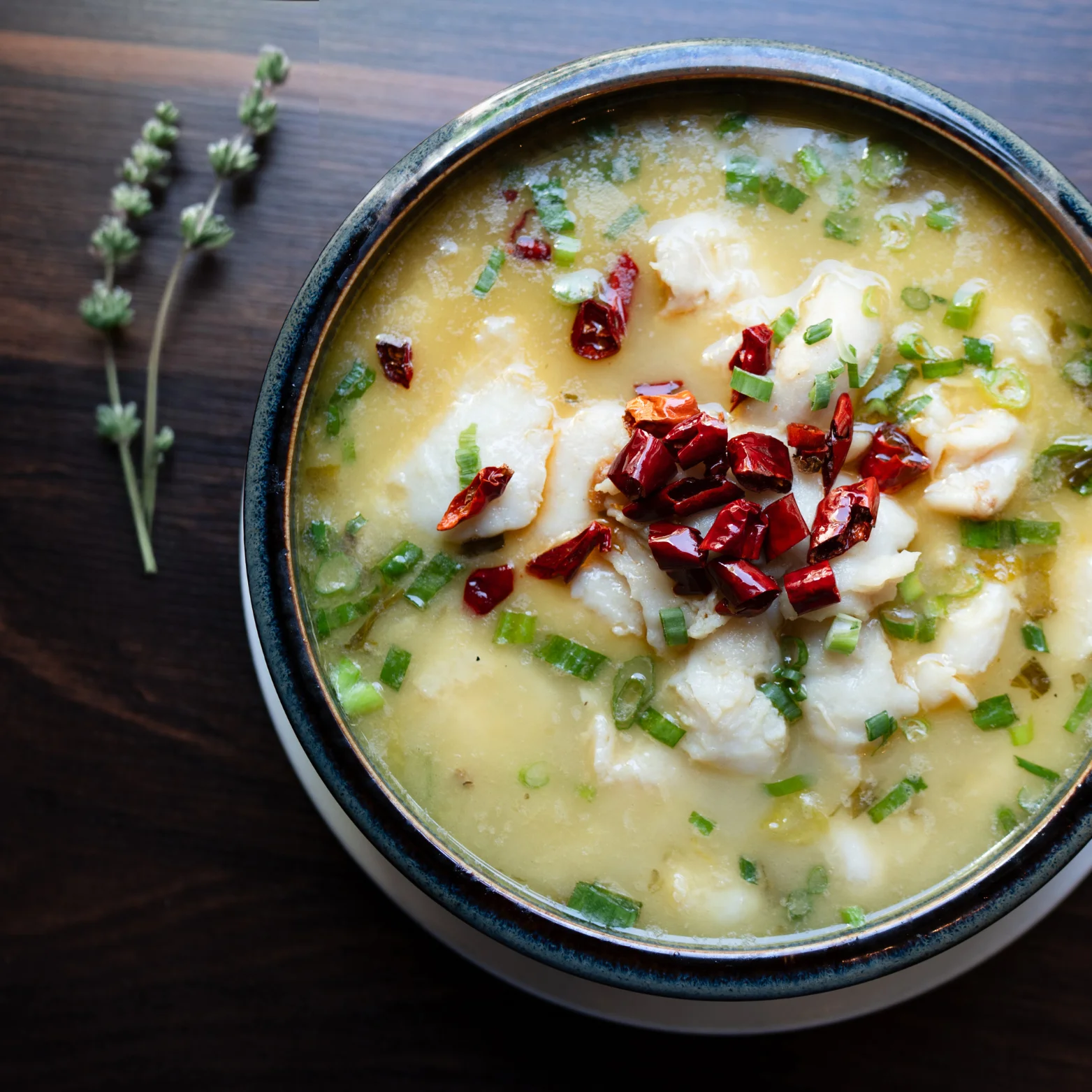 Chinese fish congee topped with dried chilies and scallions