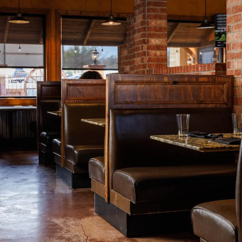 Cozy restaurant interior with leather booths and warm lighting