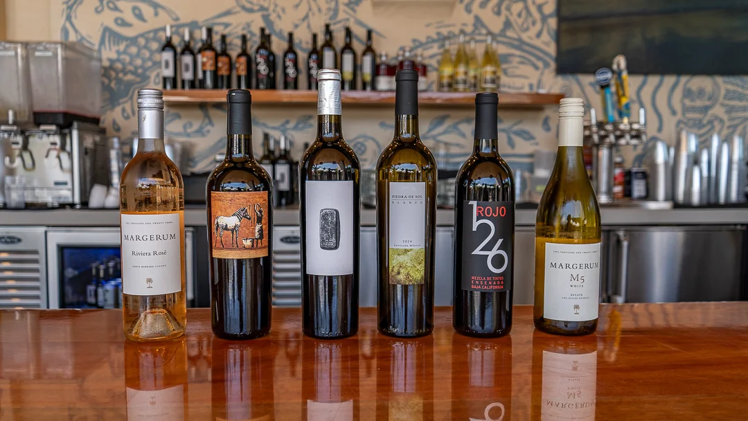 Selection of fine wines displayed on a wooden bar
