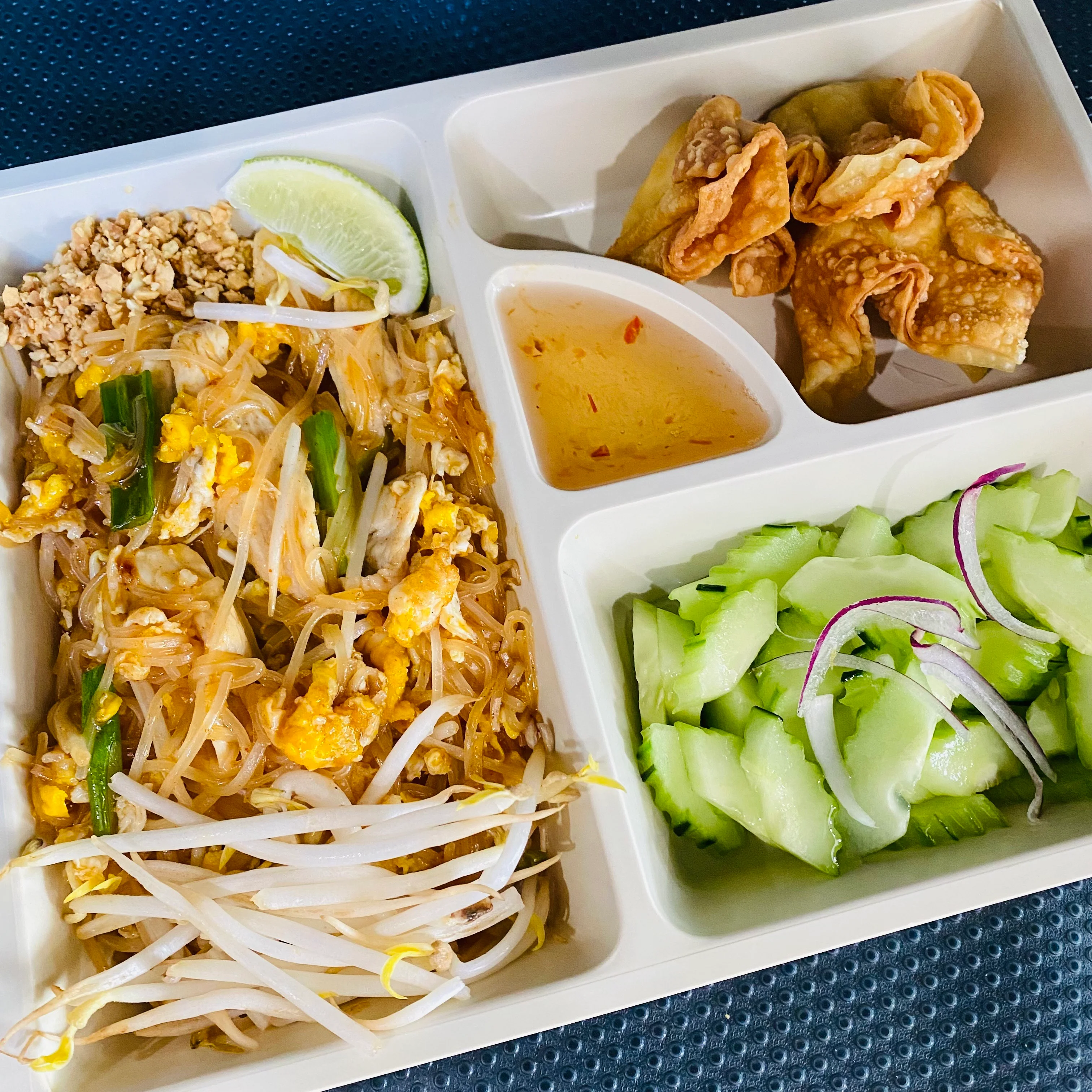 Thai pad thai with spring rolls and cucumber salad