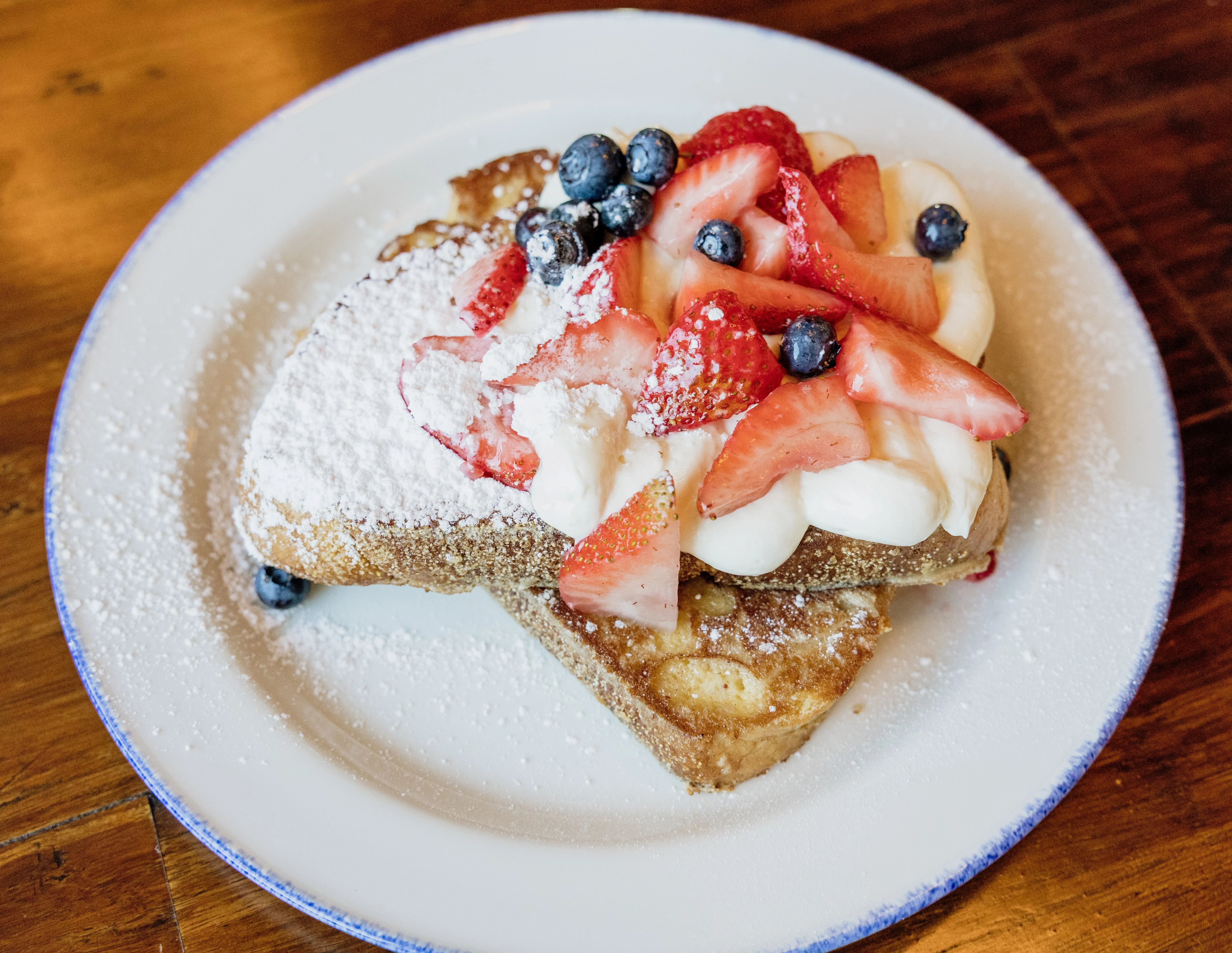 French toast topped with fresh berries and whipped cream